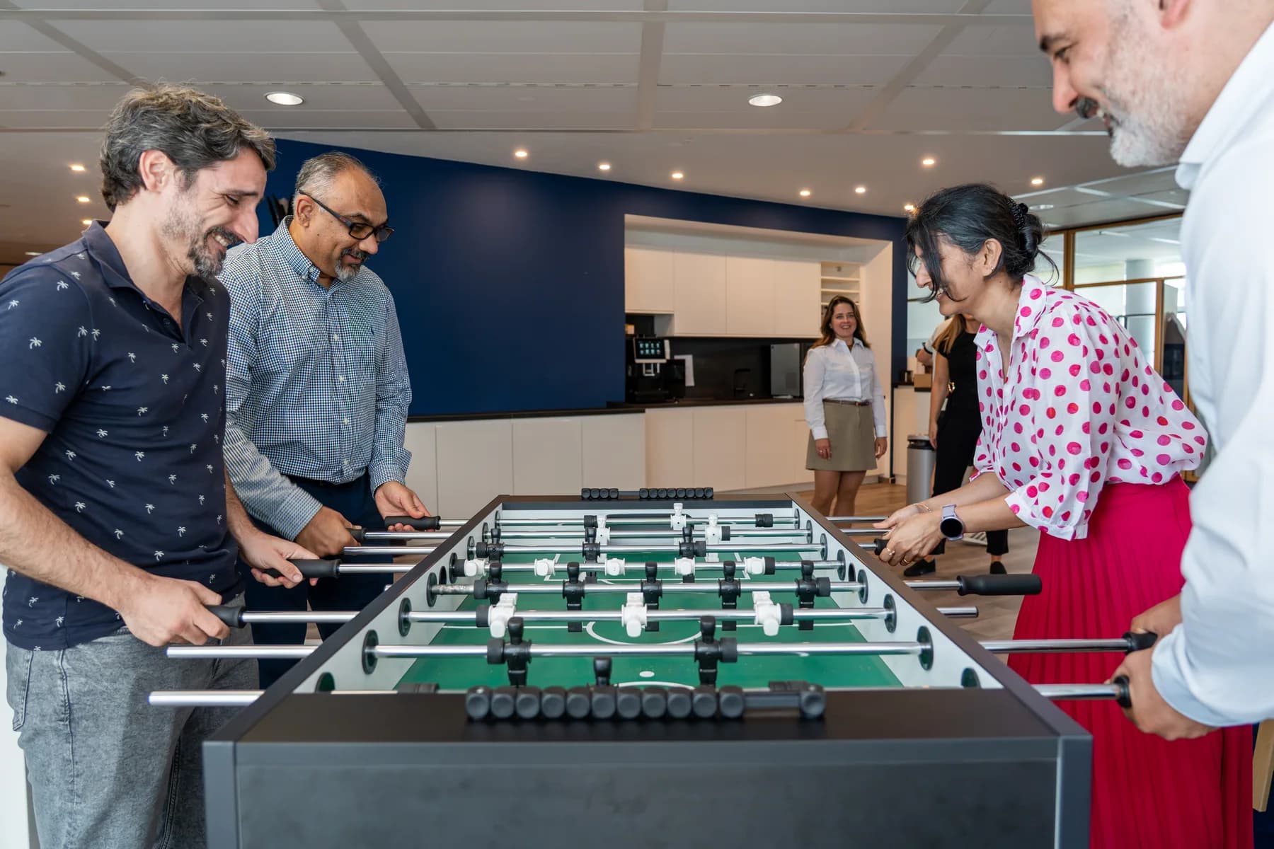 FrontWell colleagues enjoying a game of table football together in the office.