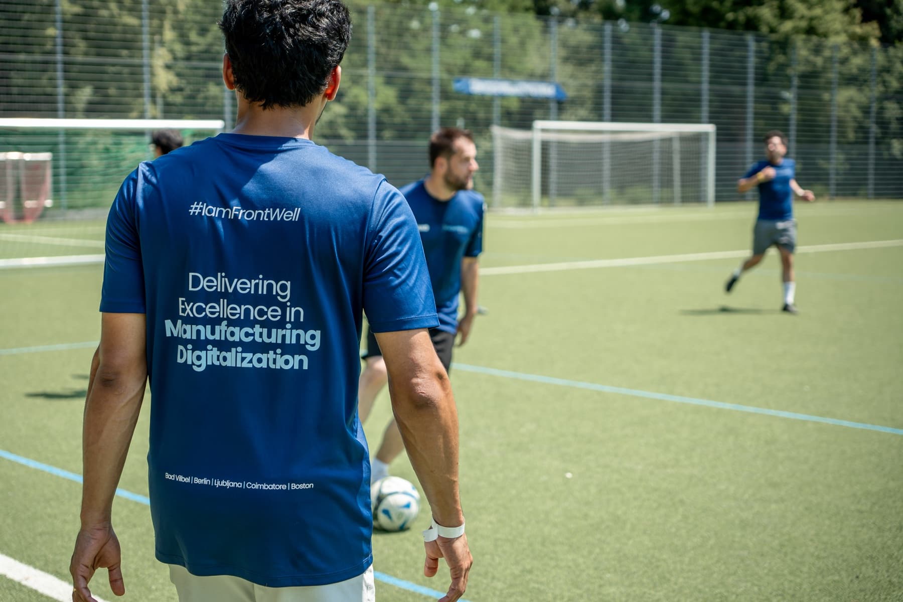 A FrontWell colleague wearing the I am FrontWell team shirt during an outdoor activity.