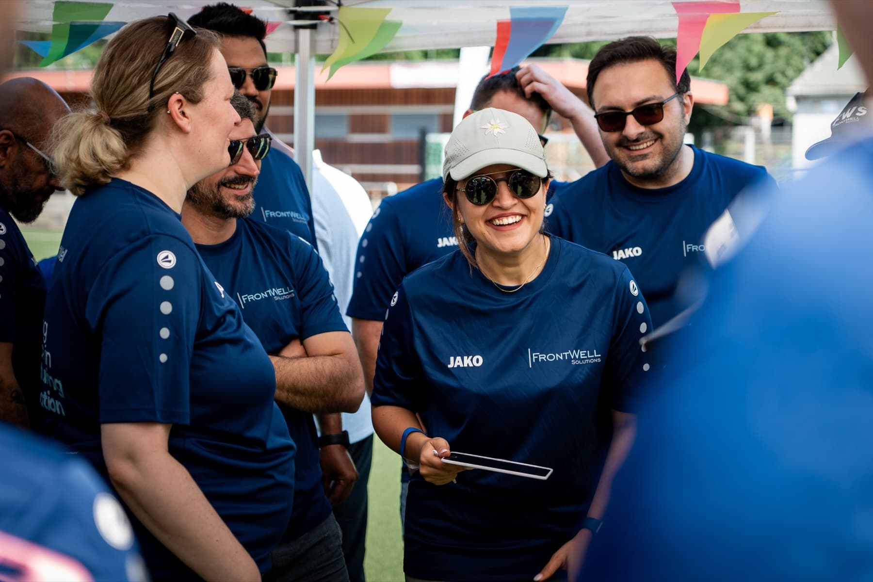 FrontWell colleagues sharing a joyful moment during a summer team event.
